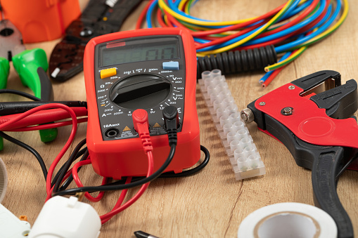 Tools for electrician needs: multimeter, voltage testers, wire strippers, pliers,