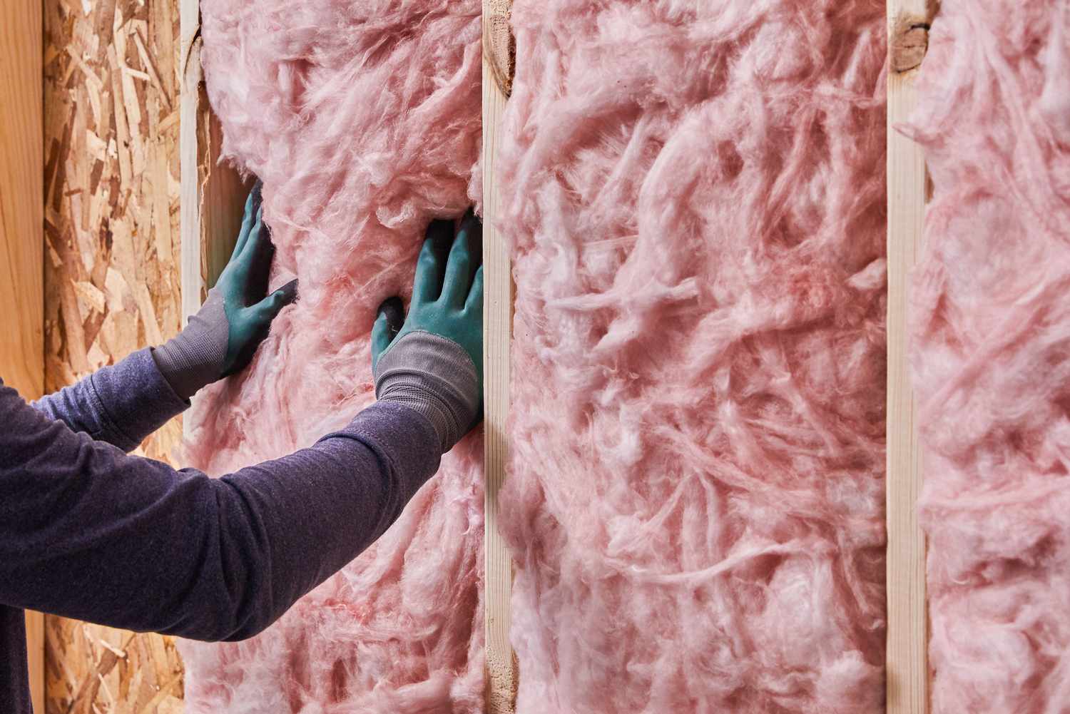 Fiberglass insulation air barrier between wall cavities