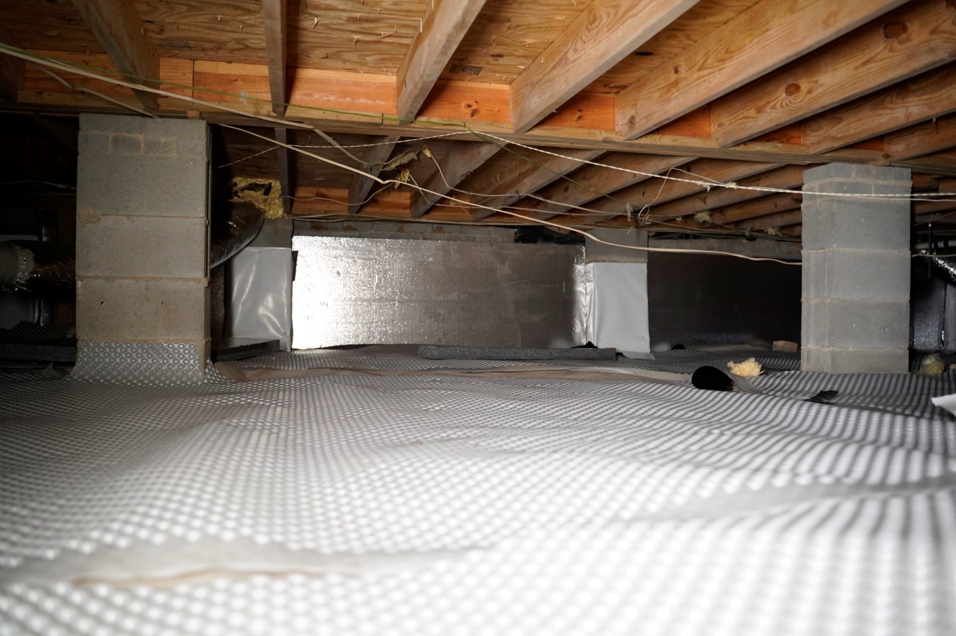 Dirt floor barrier prevents ground moisture in crawl spaces