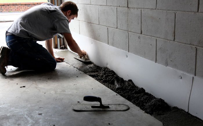 Waterproofing basement walls to protect against standing water in a leaky basement